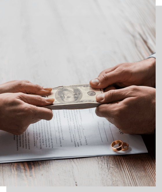 Couple holding money over divorce papers